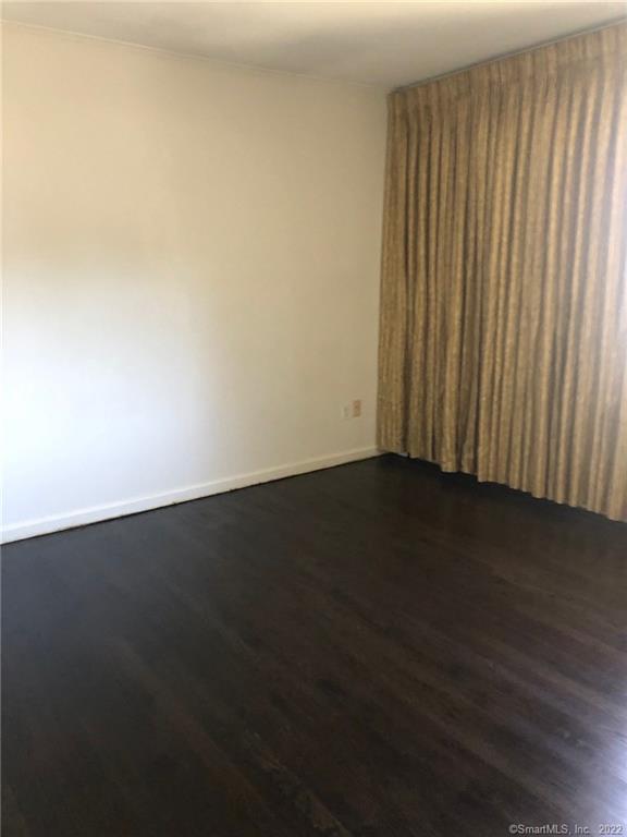 927 Burroughs Road Fairfield, CT 06825 - Photo 16 of 33 an empty room with wooden floor