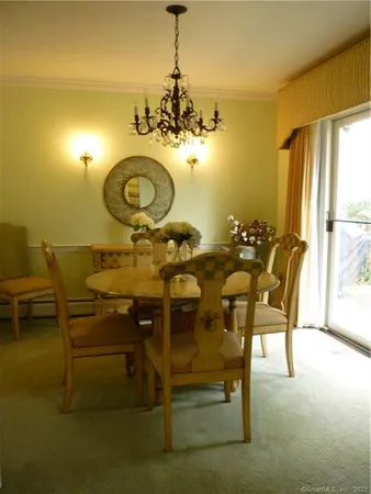 a view of a dining room with furniture and window