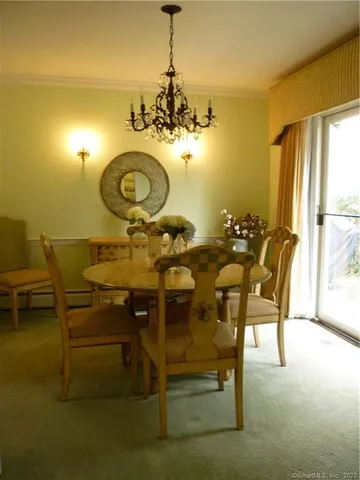a view of a dining room with furniture and chandelier