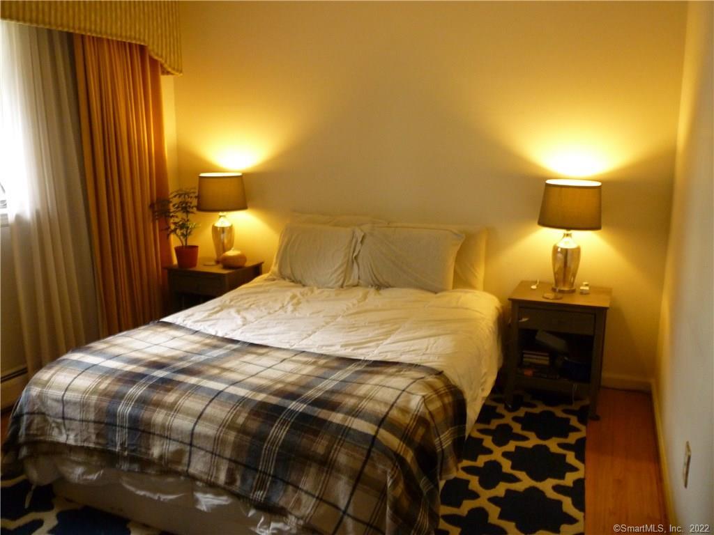 927 Burroughs Road Fairfield, CT 06825 - Photo 26 of 33 a bedroom with a bed and a lamp