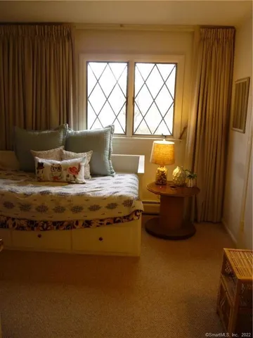 a bedroom with furniture and a window