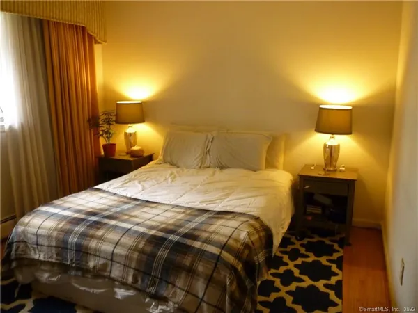 a bedroom with a bed and a window