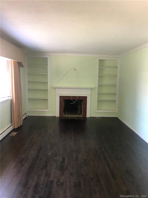 927 Burroughs Road Fairfield, CT 06825 - Photo 4 of 33 an empty room with windows and fireplace