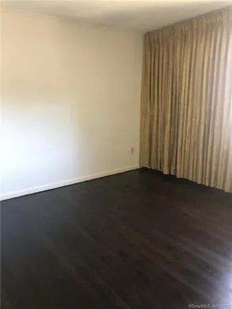 an empty room with wooden floor