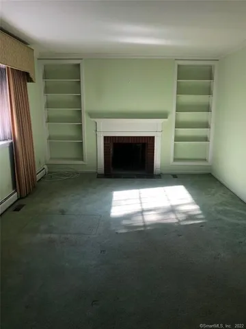 a kitchen with granite countertop a stove top oven microwave and cabinets