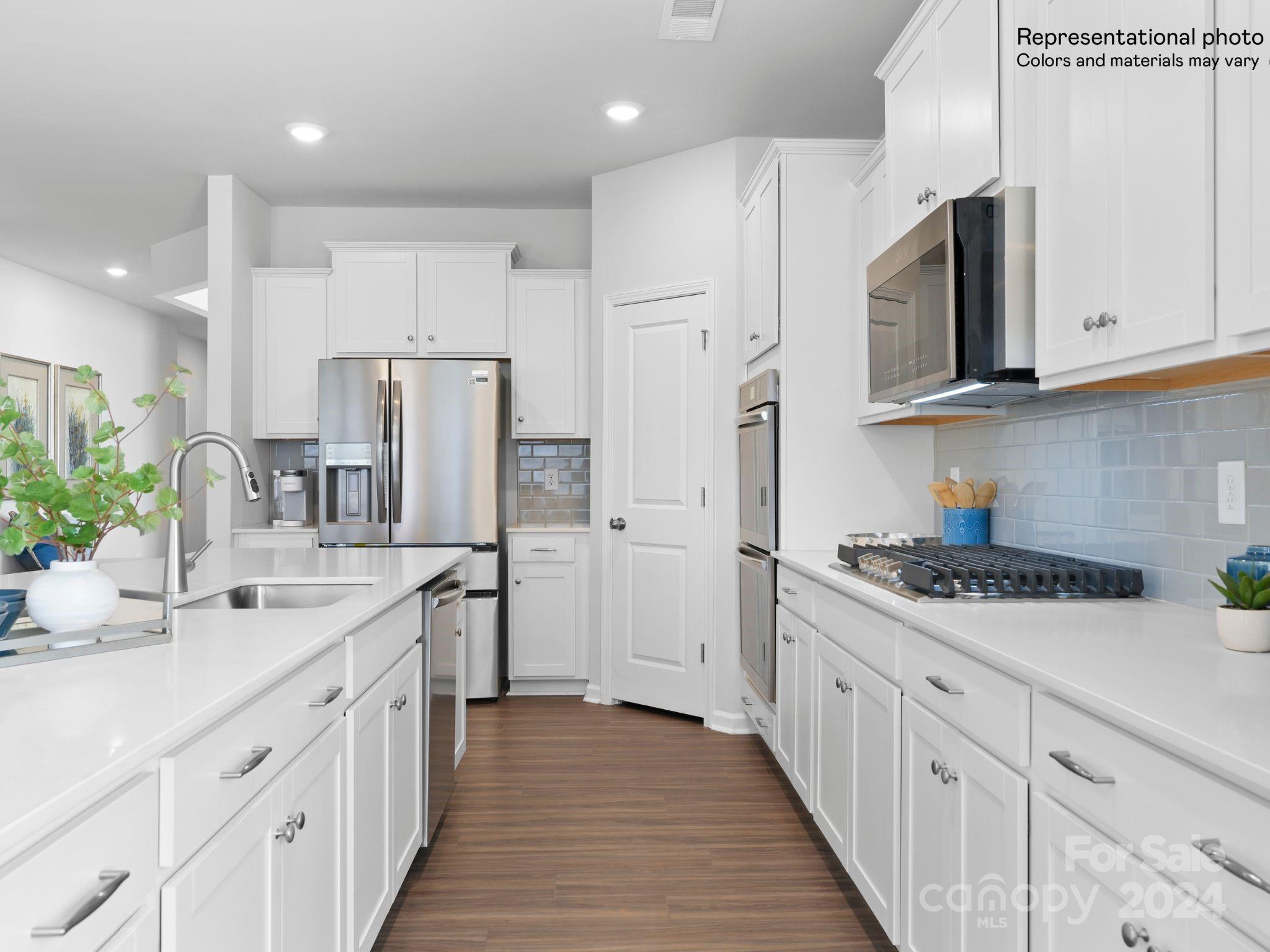 4451 Doyle Rdg Road Maiden, NC 28650 - Photo 10 of 21 a kitchen with white cabinets and stainless steel appliances