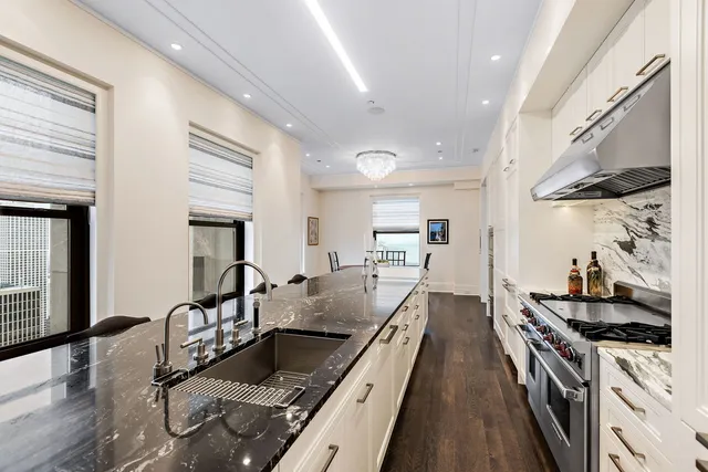a kitchen with sink stove and cabinets