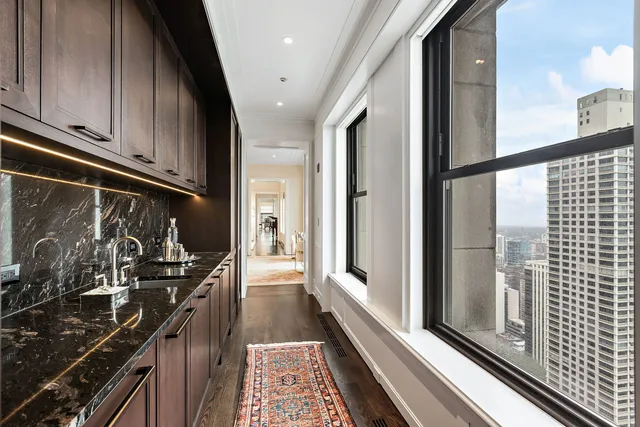 a kitchen with a sink and wooden floor