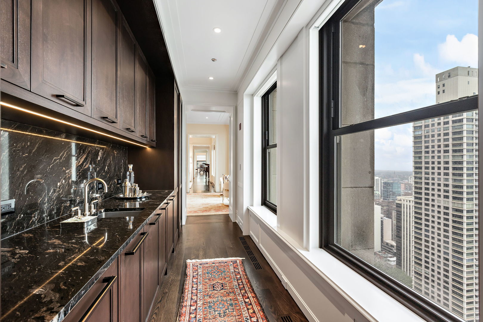 159 East Walton Place, Unit PH Chicago, IL 60611 - Photo 17 of 46 a kitchen with a sink and wooden floor