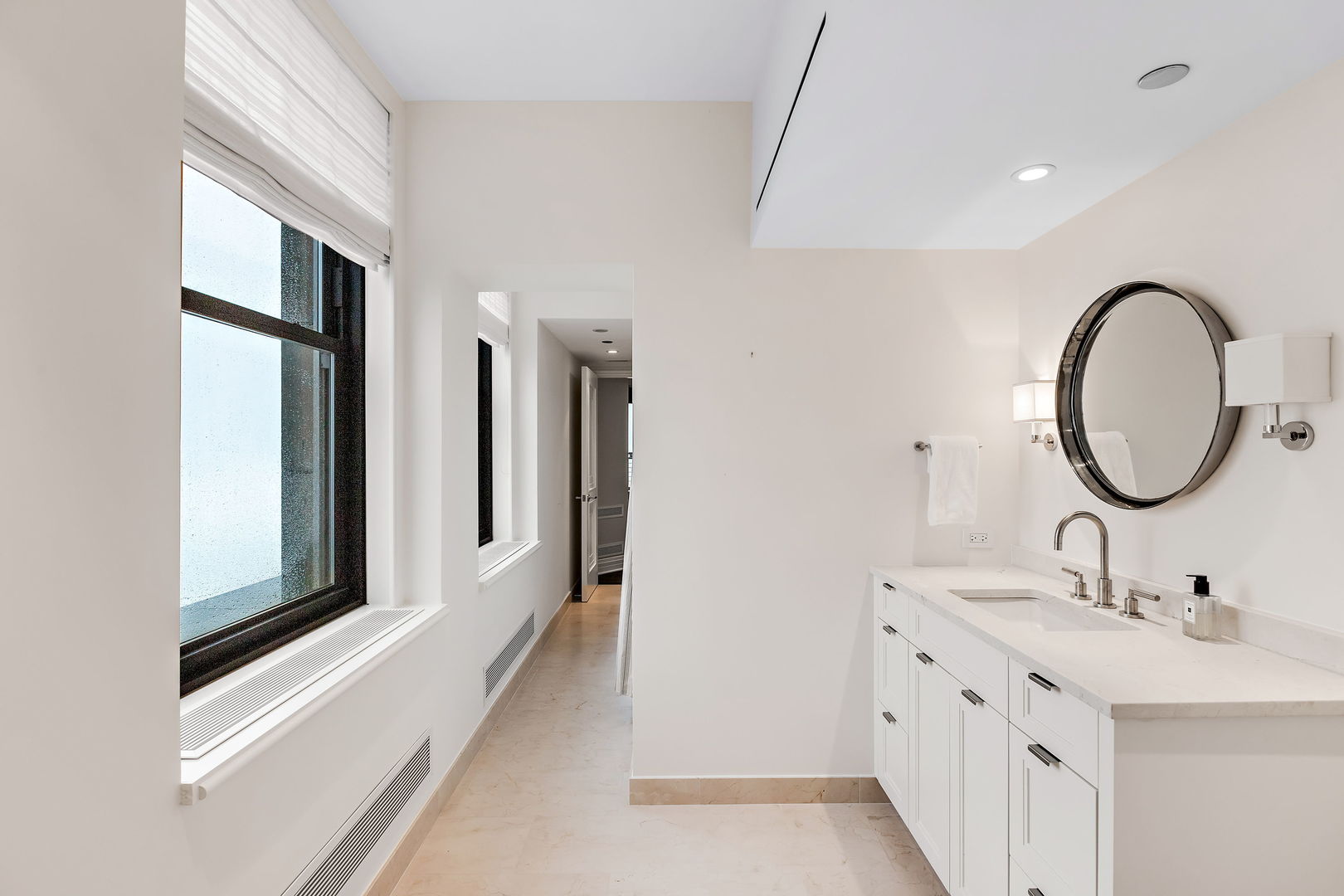159 East Walton Place, Unit PH Chicago, IL 60611 - Photo 33 of 46 a bathroom with a double vanity sink and a mirror