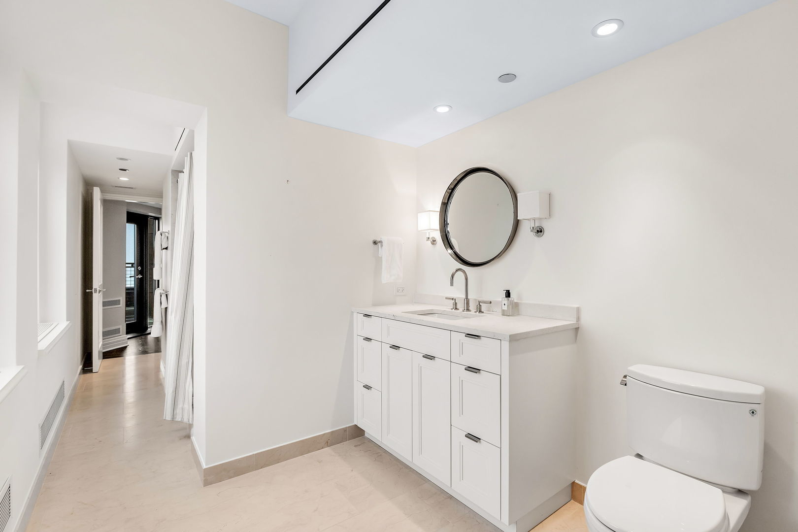 159 East Walton Place, Unit PH Chicago, IL 60611 - Photo 34 of 46 a bathroom with a toilet a sink and a mirror