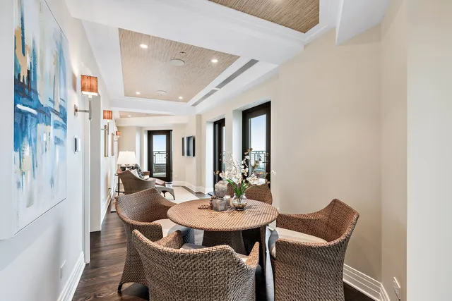 a view of a hallway with wooden floor and closet