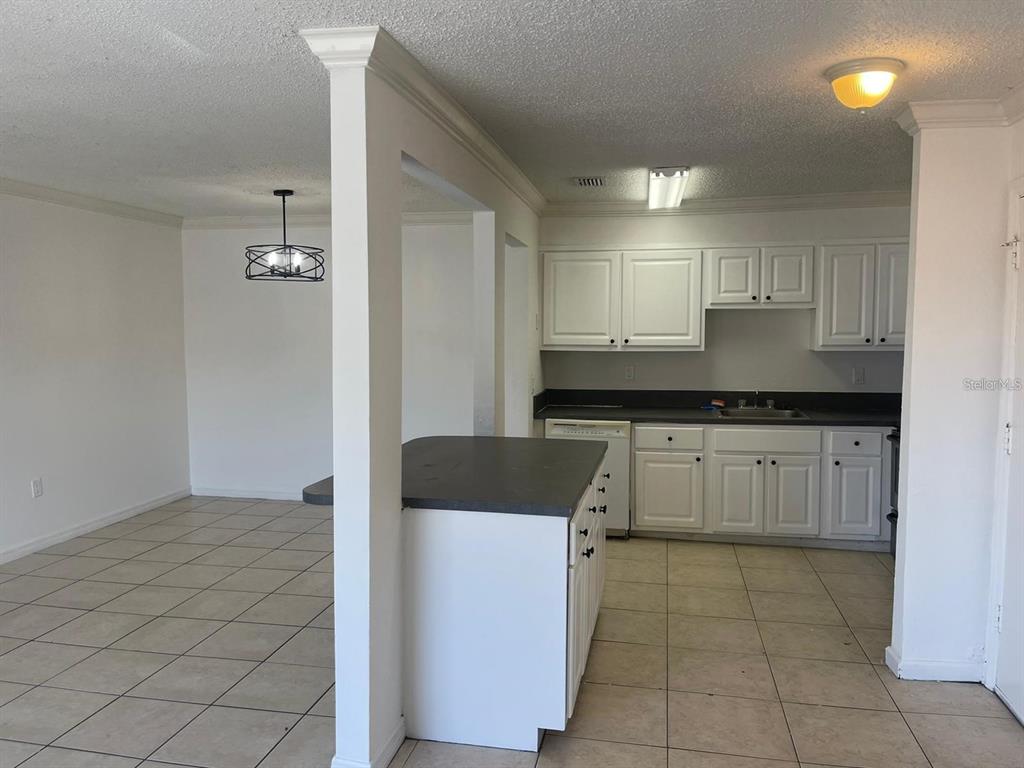 550 Flemming Way, Unit 200 Maitland, FL 32751 - Photo 2 of 11 a kitchen with a sink refrigerator and cabinets