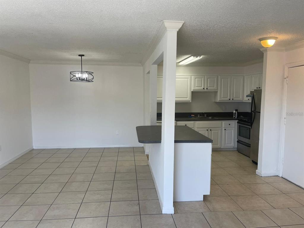 550 Flemming Way, Unit 200 Maitland, FL 32751 - Photo 3 of 11 a kitchen with a sink a stove and cabinets