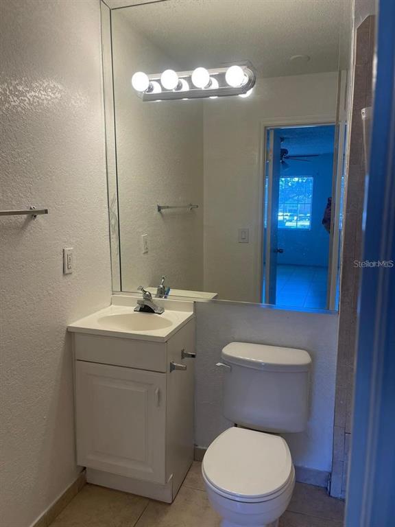 550 Flemming Way, Unit 200 Maitland, FL 32751 - Photo 5 of 11 a bathroom with a toilet a sink and mirror