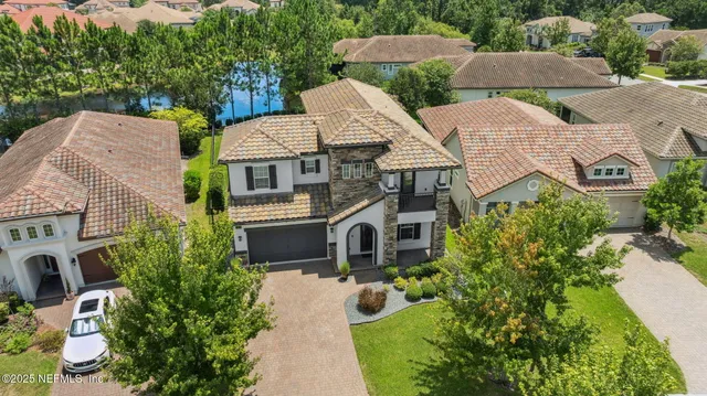 an aerial view of a house with yard and mountain view in back