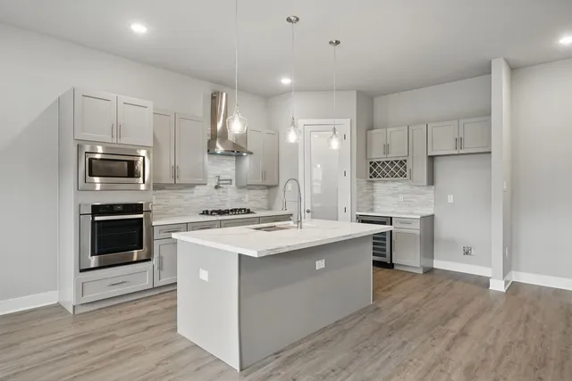 a kitchen with a stove a sink and a refrigerator