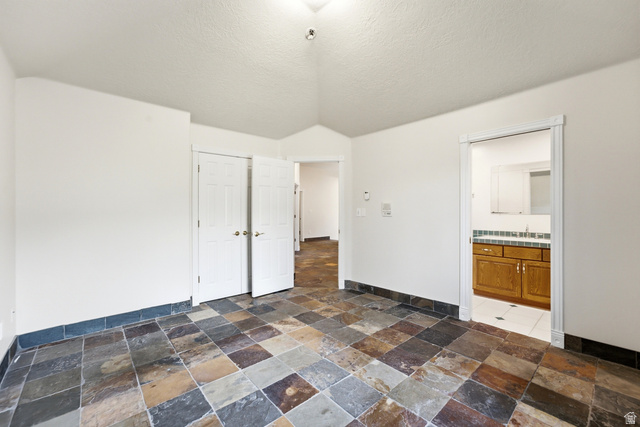3535 Homestead Road Park City, UT 84098 - Photo 69 of 81 Spacious room featuring multi-toned slate tile flooring, white walls, and a vaulted ceiling