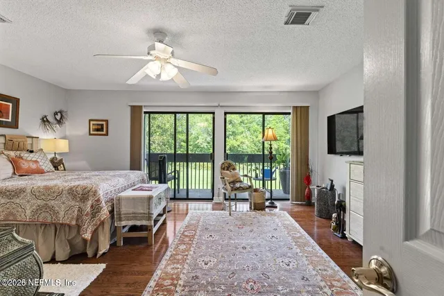 a bedroom with a bed and a large window