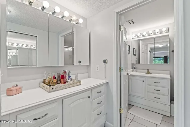 a bathroom with a sink vanity and mirror