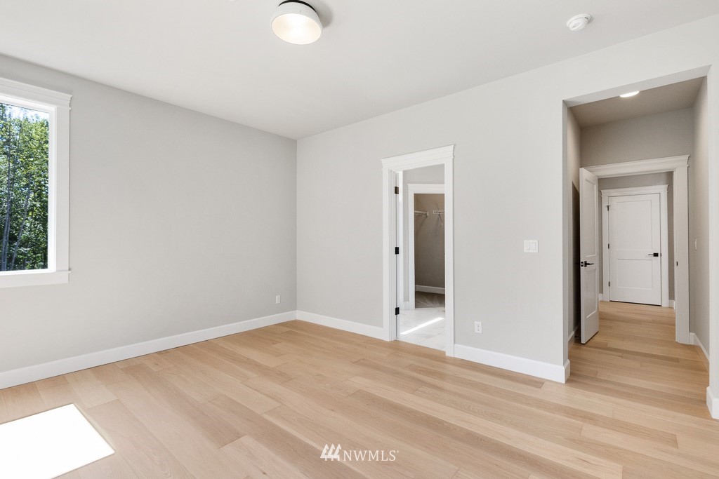 3010 230th Place Southeast Bothell, WA 98021 - Photo 11 of 17 a view of an empty room with wooden floor and a window