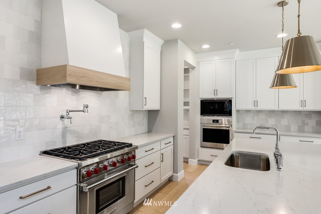 3010 230th Place Southeast Bothell, WA 98021 - Photo 5 of 17 a kitchen with white cabinets and appliances