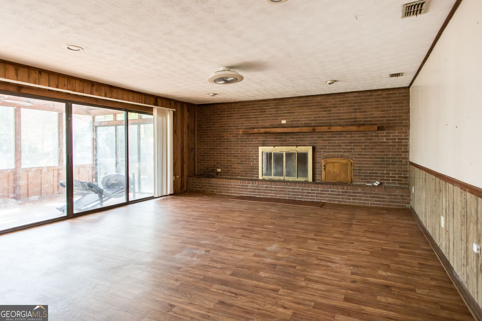 902 Stanton Avenue Waycross, GA 31503 - Photo 11 of 38 a view of empty room with wooden floor and fan