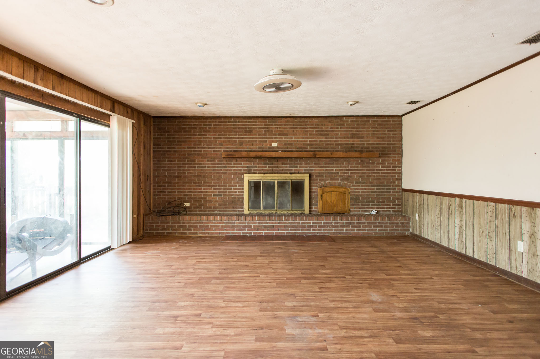902 Stanton Avenue Waycross, GA 31503 - Photo 12 of 38 a view of empty room with wooden floor and fan
