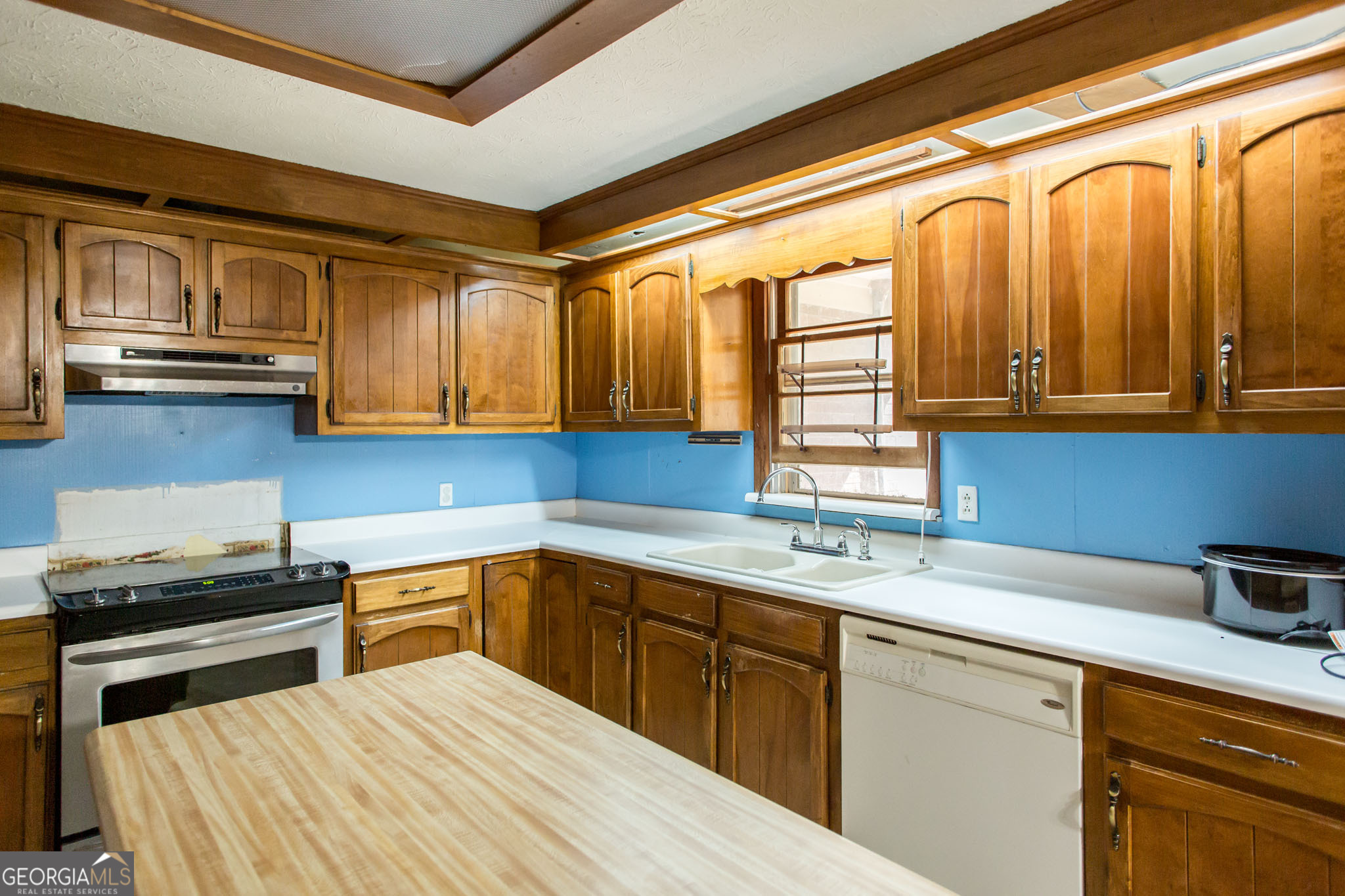 902 Stanton Avenue Waycross, GA 31503 - Photo 17 of 38 a kitchen with stainless steel appliances granite countertop a sink a stove and cabinets