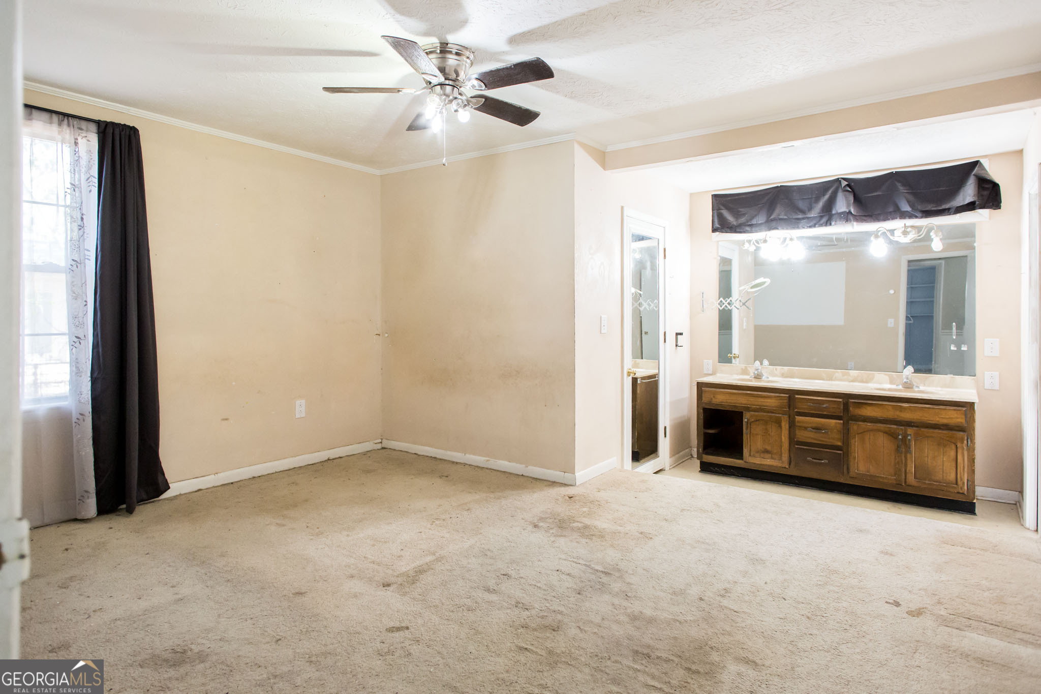 902 Stanton Avenue Waycross, GA 31503 - Photo 32 of 38 a large white kitchen with a granite countertop sink and a large mirror