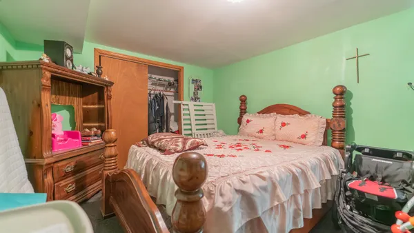 a bedroom with a bed and windows