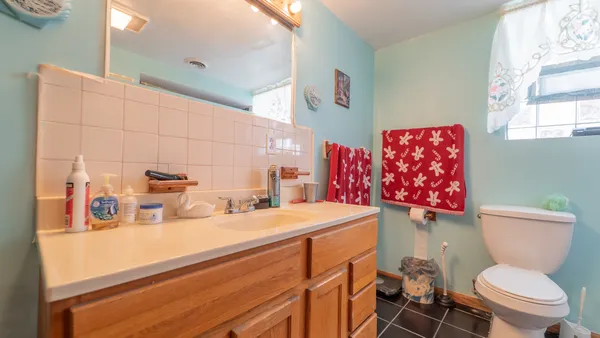 a bathroom with a sink a toilet and a shower
