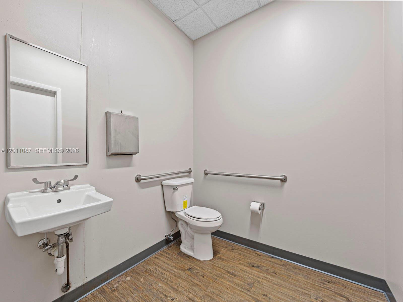 735 Shotgun Road Sunrise, FL 33326 - Photo 18 of 21 a bathroom with a sink and a toilet