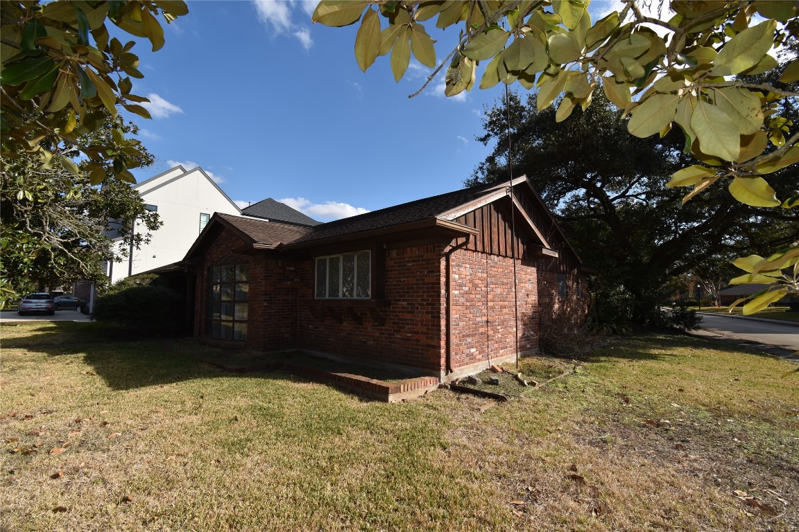 3647 Aberdeen Way Houston, TX 77025 - Photo 13 of 32 a view of a house with a yard covered with snow in front of house