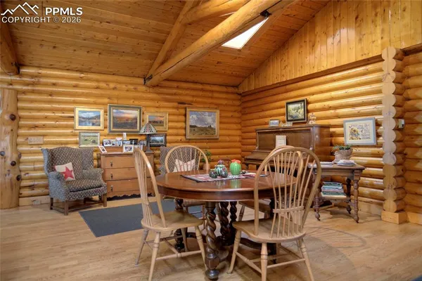 a dining room with furniture and wooden floor