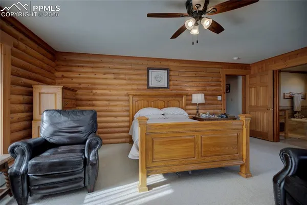 a bedroom with furniture and a ceiling fan