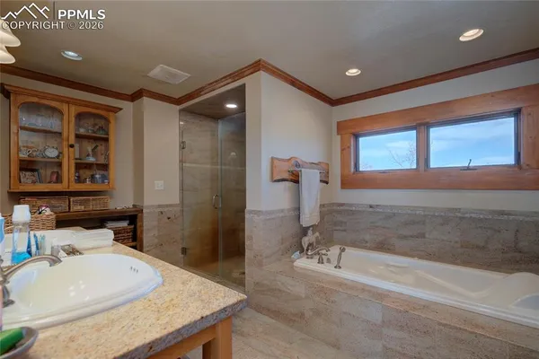 a bathroom with a granite countertop sink mirror and bathtub