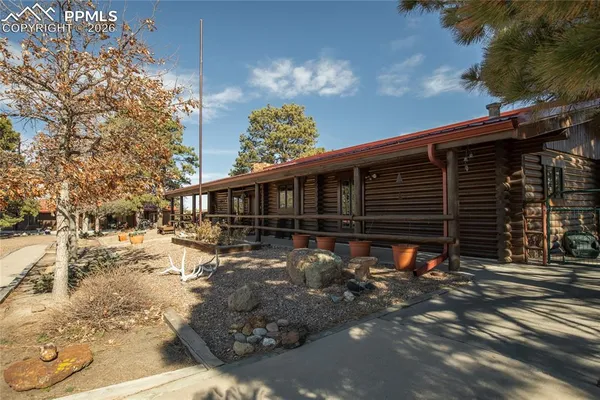 a front view of a house with a yard covered with snow