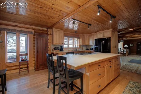 a kitchen with a cabinets and wooden floor