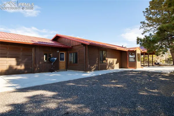 a bedroom with a bed a chandelier and a flat screen tv