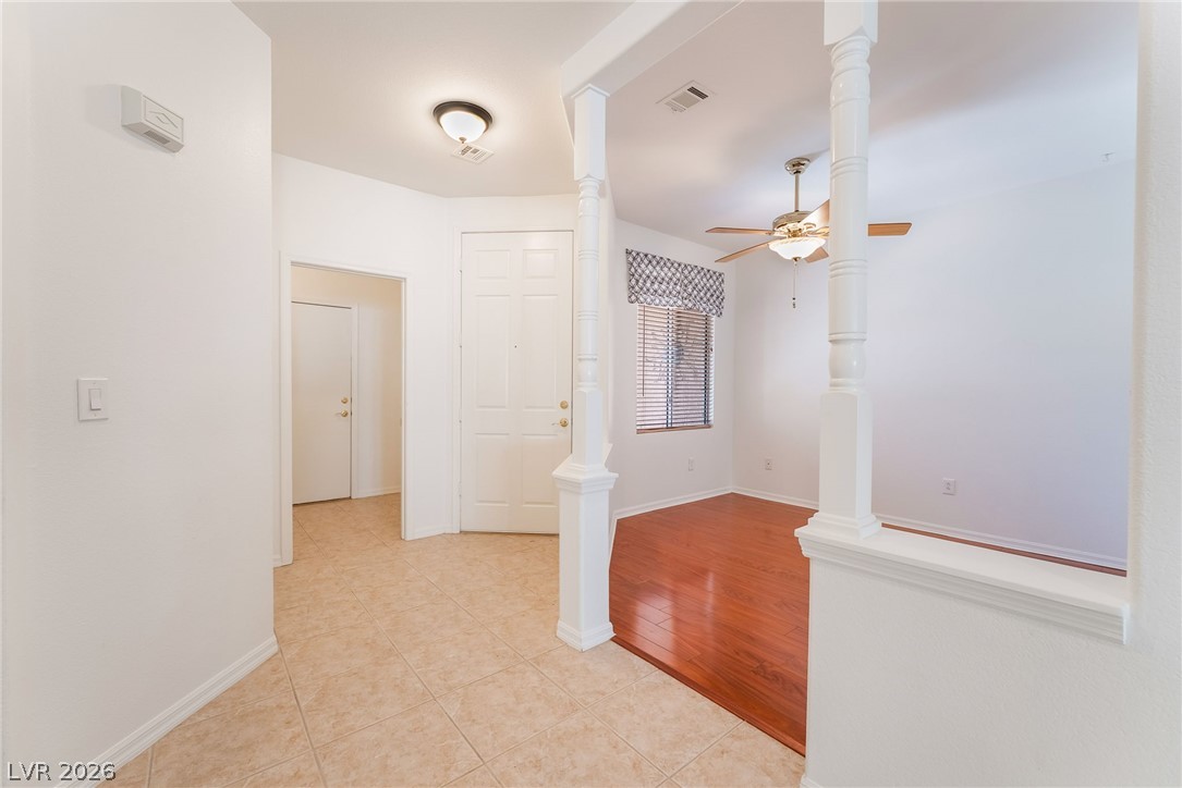 5389 Progresso Street Las Vegas, NV 89135 - Photo 7 of 41 A graceful entry flows into an adjoining space featuring rich wood flooring and a refreshing ceiling fan.