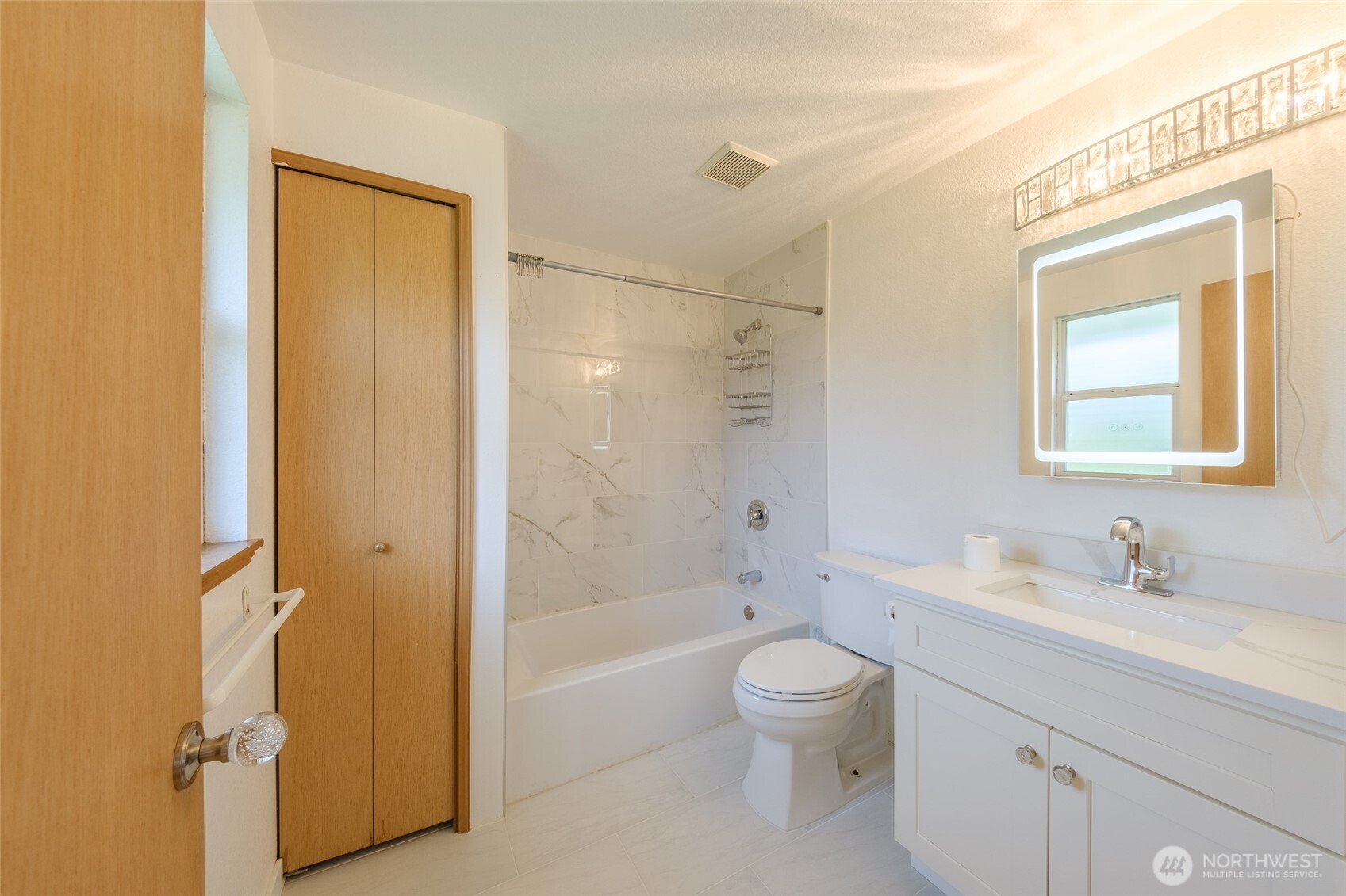 830 234th Street Southeast Bothell, WA 98021 - Photo 11 of 26 a bathroom with a granite countertop toilet a sink and a bathtub