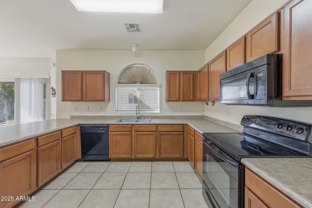 a kitchen with stainless steel appliances granite countertop a sink and stove