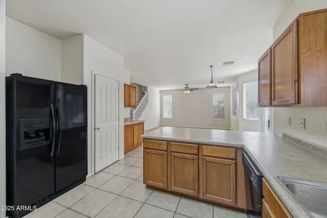 a kitchen with stainless steel appliances granite countertop a refrigerator and a sink