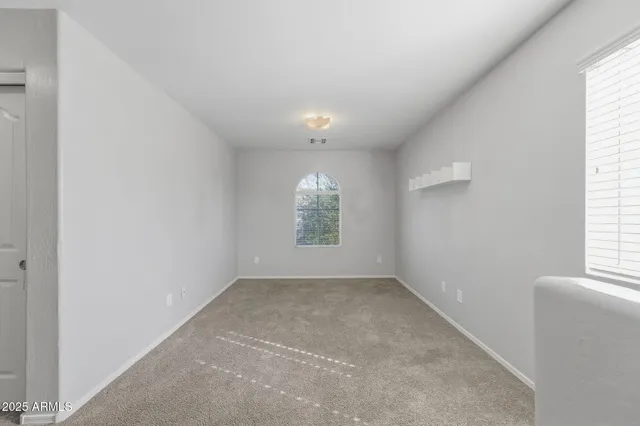 an empty room with windows and closet