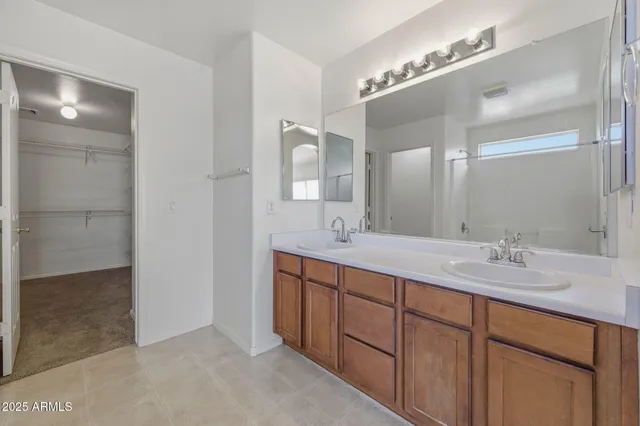 a spacious bathroom with a bathtub shower sink double and mirror