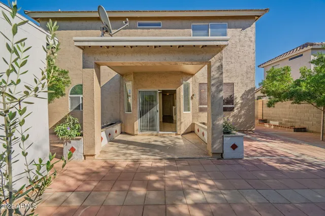 a view of a house with backyard and sitting area