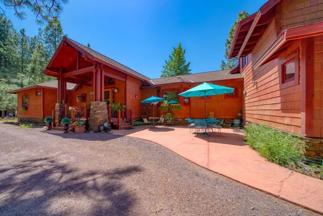 a view of a house with backyard and sitting area