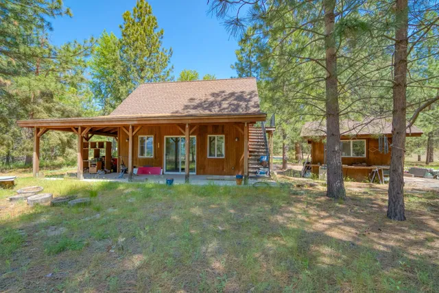 a view of a house with a yard and sitting area