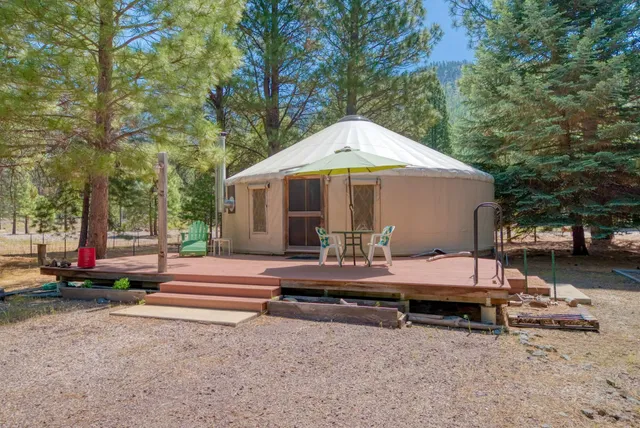 a view of backyard with swimming pool and sitting area